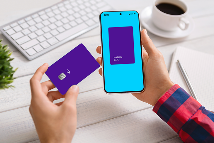Person holding a virtual card on smartphone alongside physical card for online payments